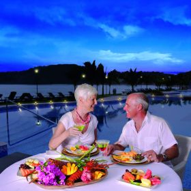 Couple eating dinner with Amadaor Causeway Panama in the distance – Best Places In The World To Retire – International Living